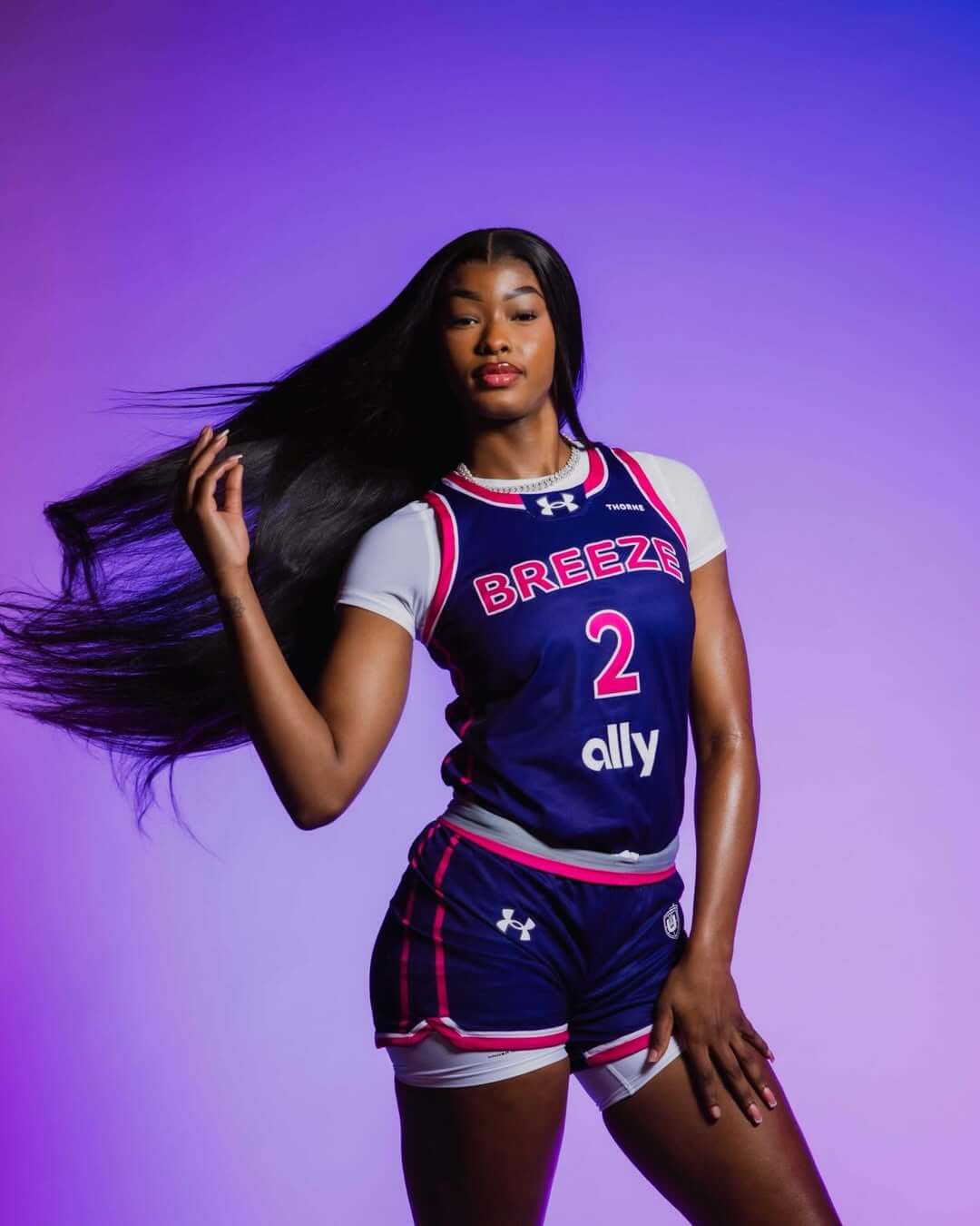 Rickea Jackson wearing a blue Breeze basketball uniform with number 2, posed against a purple background.